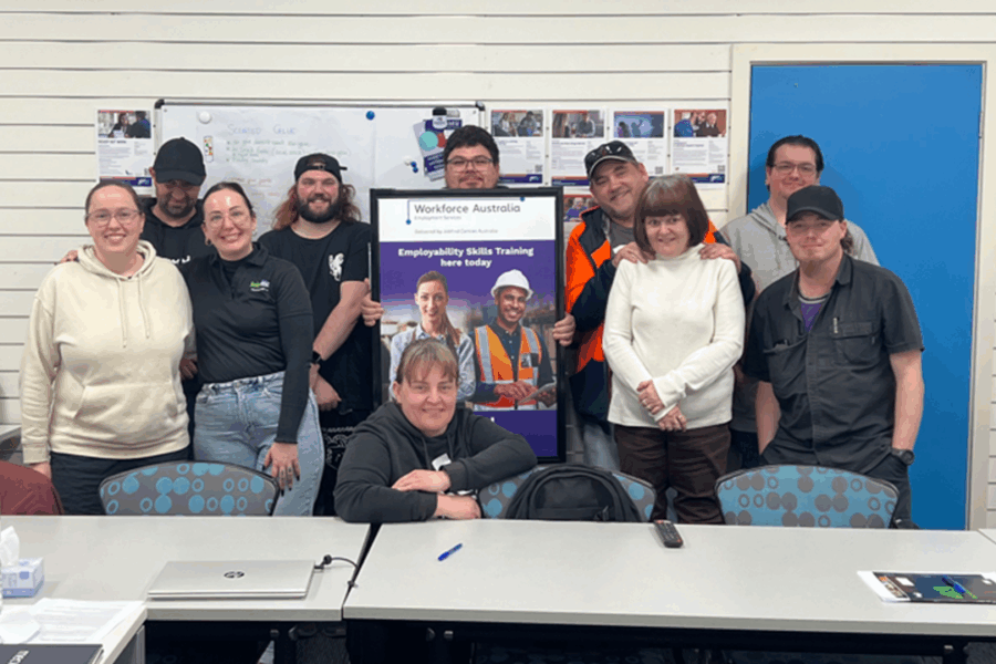 mage of EST participants and Jobfind trainers smiling facing the camera.