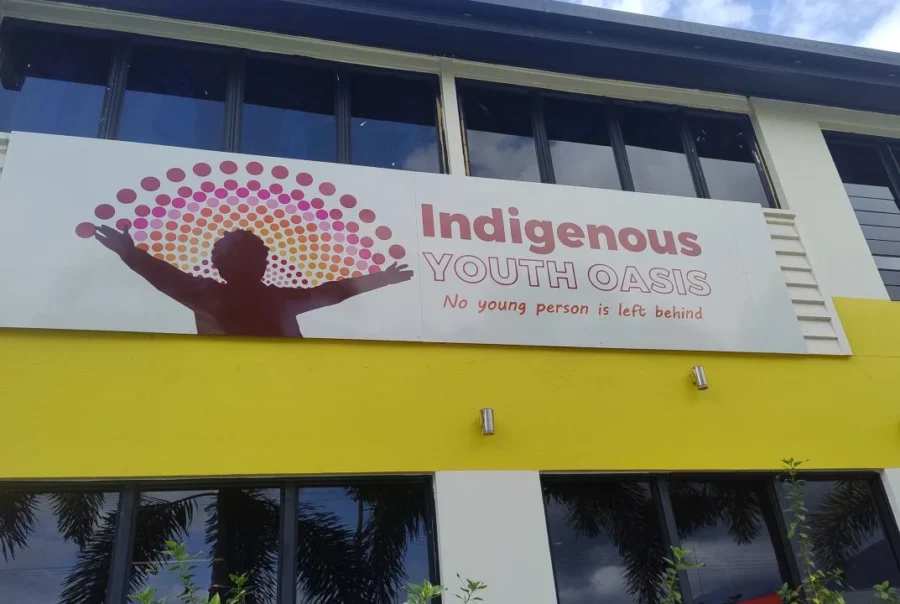 Signage with Indigenous person and characterised rainbow with name of the Indigenous Youth Oasis