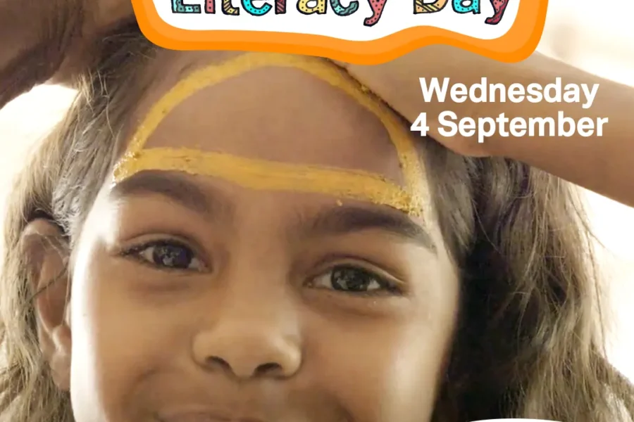 Young indigenous girl smiles at camera with the ILD logo and theme "Be a Proud Voice for Country"