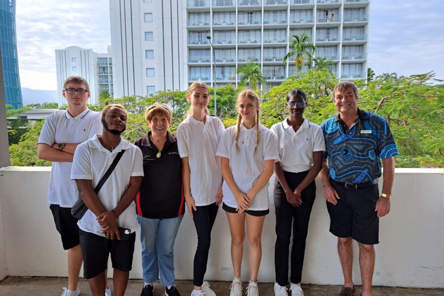 Photograph of hospitality TTW students standing on a balcony smiling and facing the camera.