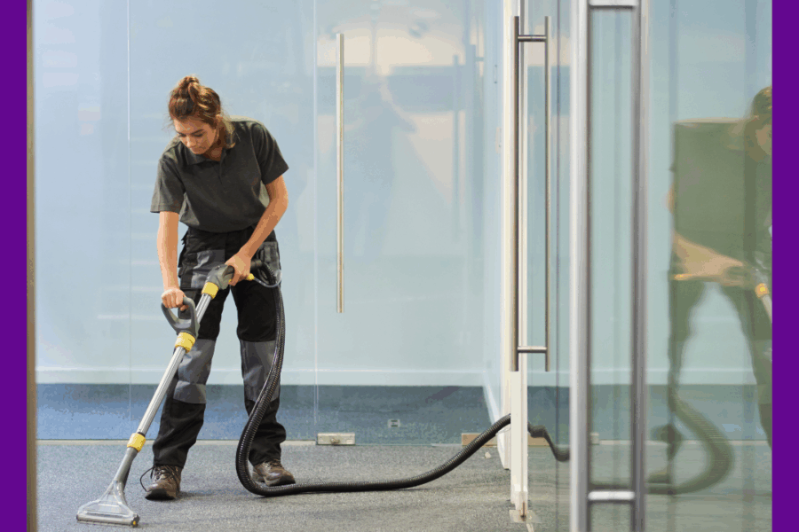 Image of a cleaner in an airport lounge hoovering.