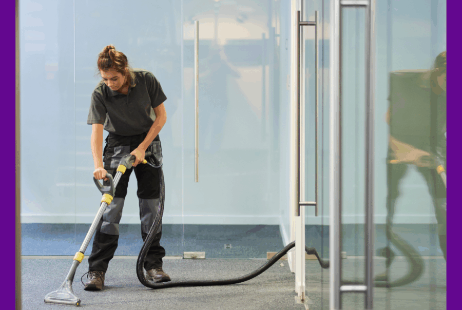 Image of a cleaner in an airport lounge hoovering.