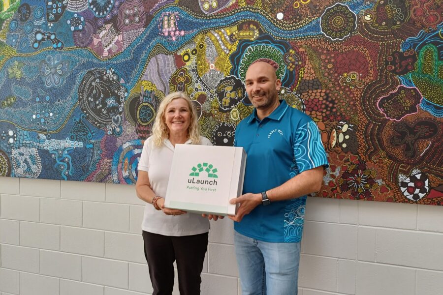 Picture of uLaunch Employment Consultant Gaynor, standing with VenuesWest representative Steven. Both smile and face the camera