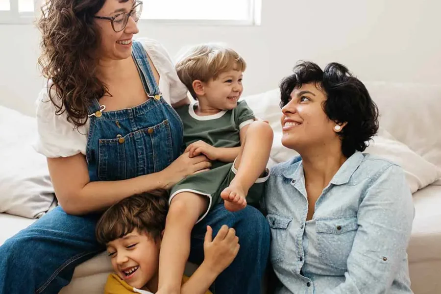 A happy family with kids laughing together at home