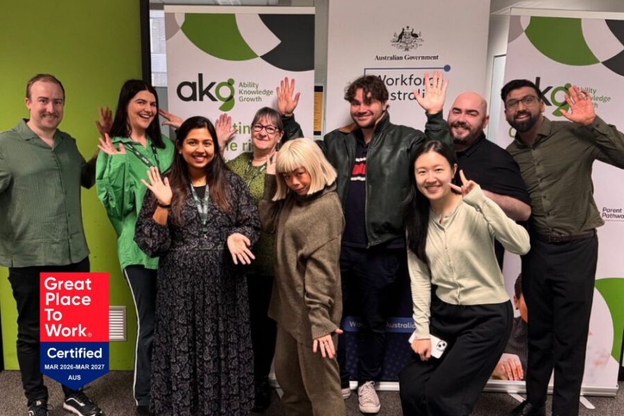AKG Achieves Great Place to Work 2026 - photo of the team together, happy and waving.