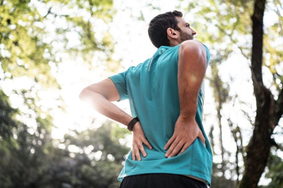 Sportsman feeling backache at a park