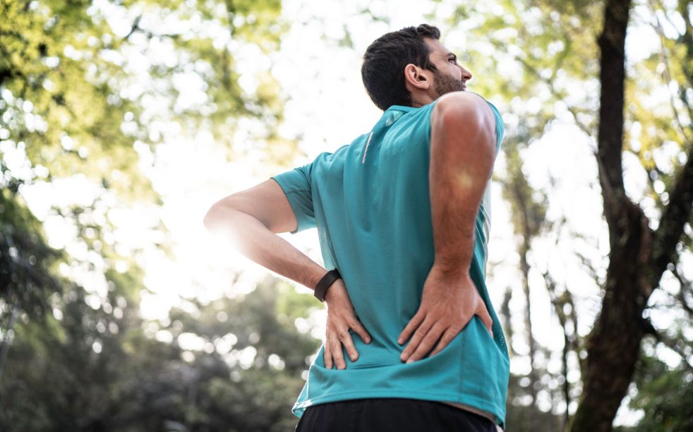 Sportsman feeling backache at a park