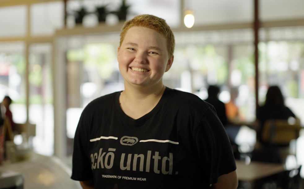 young and bright individual working in a cafe